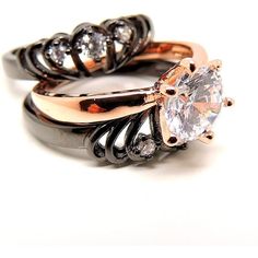 two wedding rings with diamond accents on each one and an engagement ring in the middle