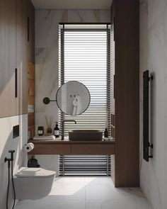 a bathroom with a toilet, sink and mirror in it's corner area next to a window