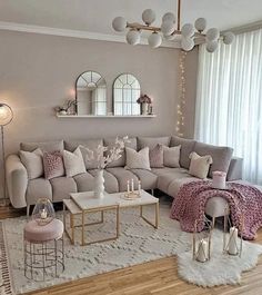 a living room filled with lots of furniture next to a white rug on top of a hard wood floor