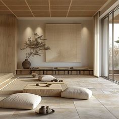 a living room filled with lots of furniture and pillows on top of floor next to windows