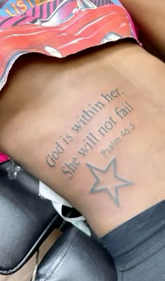 a woman with a tattoo on her stomach that says god's within she will not fail