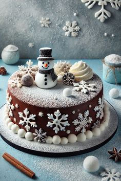 there is a cake decorated with snowmen and decorations on the top, along with cinnamon sticks