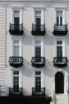 an apartment building with balconies and wrought iron railings