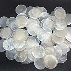 a pile of clear plastic discs on a black surface