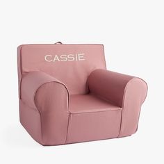 a pink children's chair with the word casssie written on it in white lettering