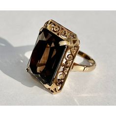 This is part of Chairish’s Fine Jewelry assortment.  Rectangular Smoky Topaz 14k Yellow Gold Filigree Cocktail Ring, 15 carat  Ring Size: 6.5 in. Stone Size: 18.38 mm x 13.11 mm x 8.32 mm Ring Weight: 7.2 grams Approximately 7.094 carats.  If you would like more information, please contact me via email, mrboult@gmail.com. Smoky Topaz Ring, Mellow Autumn, Antique Appraisal, Yellow Gold Cocktail Ring, Smoky Topaz, Gold Topaz, Gold Cocktail Ring, Gold Cocktail, Gold Filigree