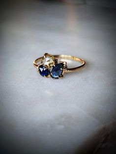 three stone ring sitting on top of a table