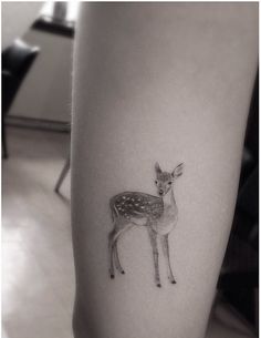 a small deer tattoo on the right thigh, and an image of a fawn