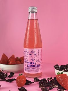 a bottle of water with strawberries on the table