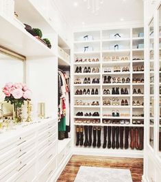 a walk in closet filled with lots of white drawers and shoes on top of shelves