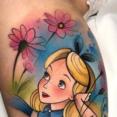 a girl with blonde hair and blue eyes has a tattoo on her arm