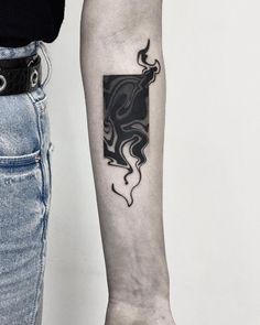 a woman's arm with a black and white tattoo design on the left forearm