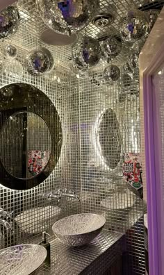 a bathroom with mirrors and lights on the ceiling