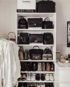 a white closet filled with lots of purses and handbags on top of shelves