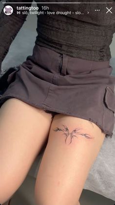 a woman's thigh with a small tattoo on it