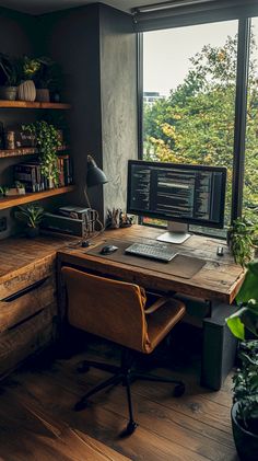 a desk with a computer on top of it next to a window and some potted plants