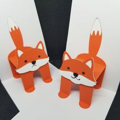 two origami foxes made out of paper