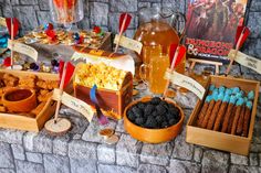 a table topped with lots of food next to a bottle of beer and other items