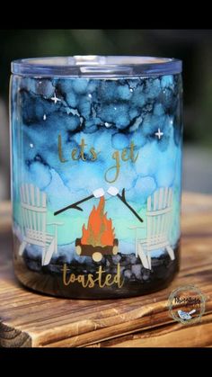 a glass jar with the words let's get toasted on it sitting on top of a wooden table