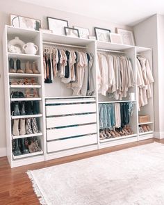 a white closet filled with lots of different types of clothes and shoes on top of shelves