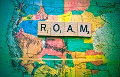 the word roam spelled out in scrabble letters on a map with colorful colors