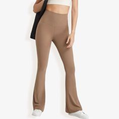 Elevate your athleisure look with these Anna-Kaci Women's High Waist Flare Leggings. Featuring a flattering high-waisted fit, these leggings provide ultimate comfort and support throughout your day. The flare leg design adds a stylish twist to the classic legging silhouette, making them perfect for yoga sessions, casual outings, or relaxing at home. Made from a soft, stretchy fabric, these leggings offer flexibility and breathability, ensuring a comfortable wear for any activity. Pair them with Comfortable Yoga Pants, The Flare, Bottom Workout, Flared Leggings, High Waist Yoga Pants, Stretchy Leggings, Stretch Leggings, Flare Leggings, Layered Skirt