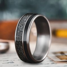 a wedding band with black and silver glitter in it