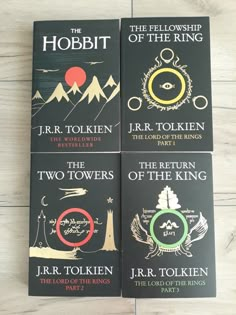 three books sitting on top of a wooden floor next to each other, the lord of the rings and the fellowship of the rings