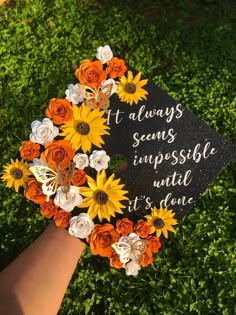 a graduation cap with sunflowers and roses on it that says, always seeing impossible until it's done