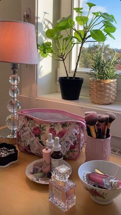 the table is full of cosmetics and other items on it, along with a potted plant