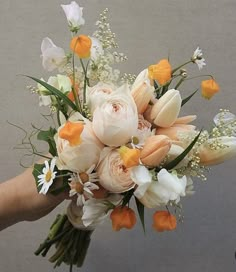 a bridal bouquet with orange and white flowers