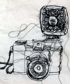 a drawing of a camera is shown on a piece of paper that has been drawn