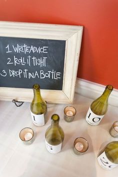 wine bottles are lined up in front of a chalkboard