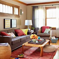 a living room filled with lots of furniture and decor on top of a hard wood floor