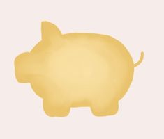 a yellow pig sitting on top of a white surface