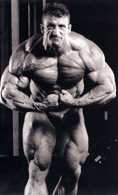 a man posing for the camera with his huge muscles