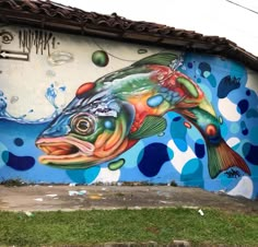 a large fish painted on the side of a building