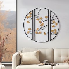 a living room filled with furniture and a round metal wall art piece on the wall