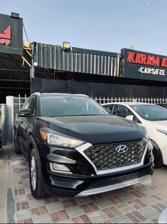 several cars parked in front of a car dealership