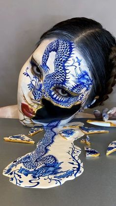 a woman with blue and white paint on her face