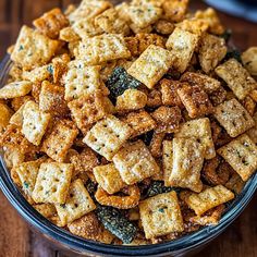 a bowl filled with crackers on top of a wooden table