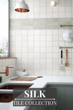 a kitchen with white tiles and wooden utensils