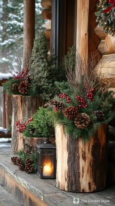 some pine cones and evergreens are on the porch with a lantern in front of them