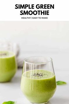 two glasses filled with green smoothie on top of a white table next to leaves