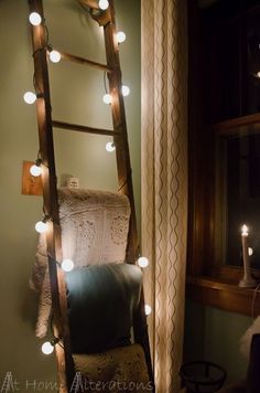 a ladder is lit up with fairy lights