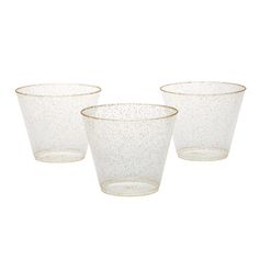 three clear glass cups with gold rims