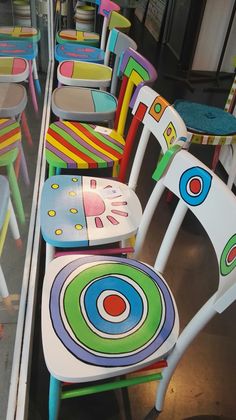 many colorful chairs are lined up on the floor