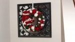 a red and white wreath hanging on the wall