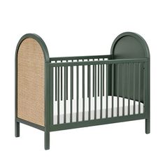 a green crib with a wicker bed frame