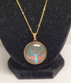 Stainless steel gold tree of Life necklace Width: 2 1/2cm Height: 2 1/2cm Chain length: 19 1/2 Cadmium-free Metal Round Pendant Jewelry, Cadmium-free Bronze Jewelry Gift, Spiritual Gold Copper Jewelry, Spiritual Gold Jewelry With Copper, Spiritual Copper Jewelry In Gold Color, Spiritual Round Metal Charm Necklaces, Nickel-free Gold Plated Spiritual Necklaces, Nickel-free Gold Spiritual Necklaces, Spiritual Metal Charm Necklace With Round Shape